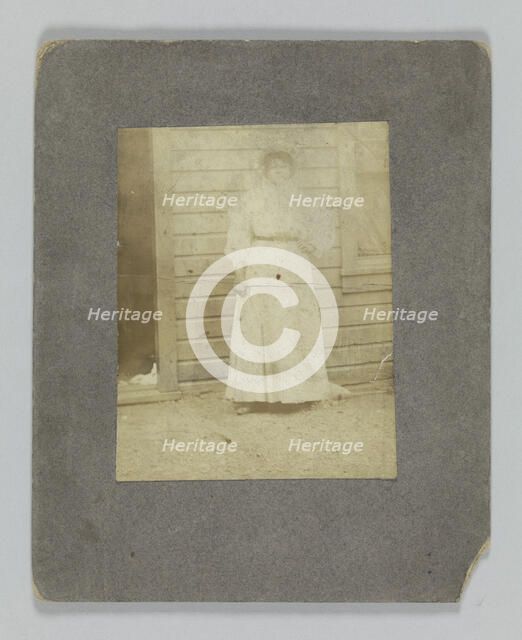 Photographic print of a woman in front of a building, late 19th century. Creator: Unknown.