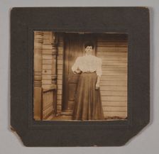 Photographic print of a woman on a porch, early 20th century. Creator: William O. Turner