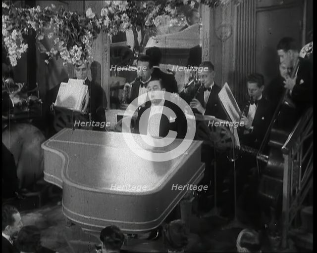 Pianist Playing the Piano and Singing "Stormy Weather", 1936.  Creator: British Pathe Ltd.