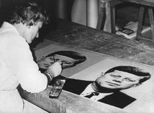 Pictures of President Kennedy being prepared to decorate the streets of Vienna, Austria, 1961