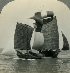 Picturesque Chinese Junk under Full Sail on the Yellow Sea, Coast of Manchukuo in Distance c1930s Creator: Unknown