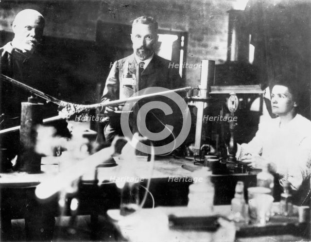 Pierre and Marie Curie, French scientists, at work in the laboratory. Creator: Unknown.