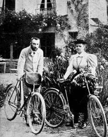 Pierre and Marie Curie, French physicists, preparing to go cycling. Creator: Unknown