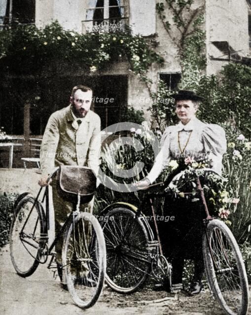 Pierre and Marie Curie, French physicists, preparing to go cycling. Artist: Unknown.