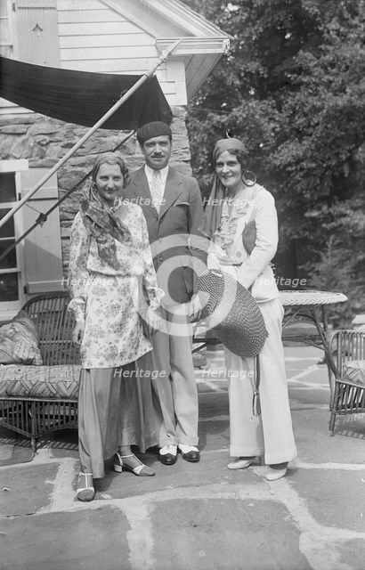 Pierre de Beaumont and two unidentified women, standing outdoors, between 1932 and 1942. Creator: Arnold Genthe.
