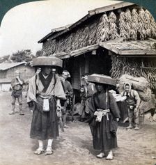 Pilgrim beggars beating little gongs, near Lake Kawaguchi, Japan, 1904. Artist: Underwood & Underwood