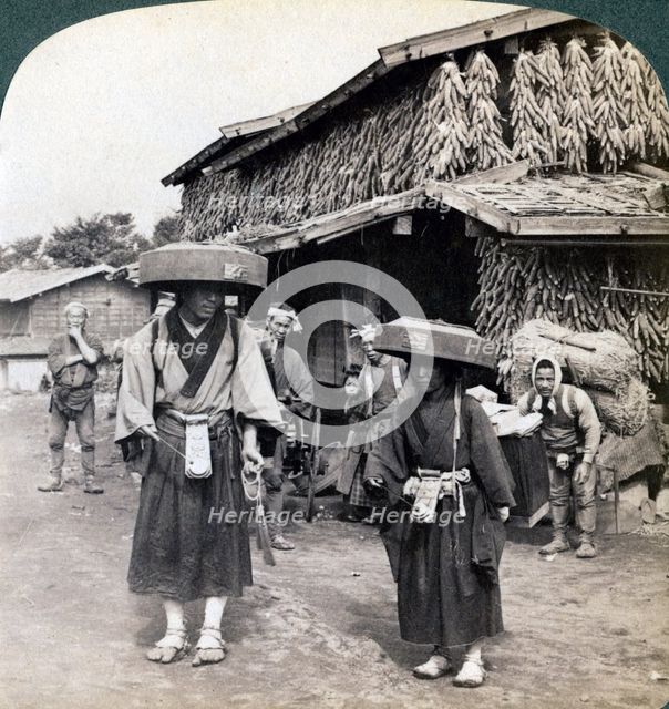 Pilgrim beggars beating little gongs, near Lake Kawaguchi, Japan, 1904. Artist: Underwood & Underwood