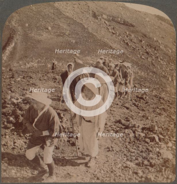 'Pilgrims, at end of weary ascent, in worship encircling crater of sacred Fujiyama, Japan', 1904. Artist: Unknown.