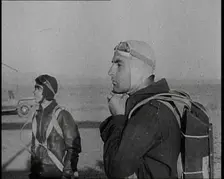 Pilot and Rear Gunner of Biplane Readying Themselves To Board Their Plane With One Adjusting...,1937 Creator: British Pathe Ltd