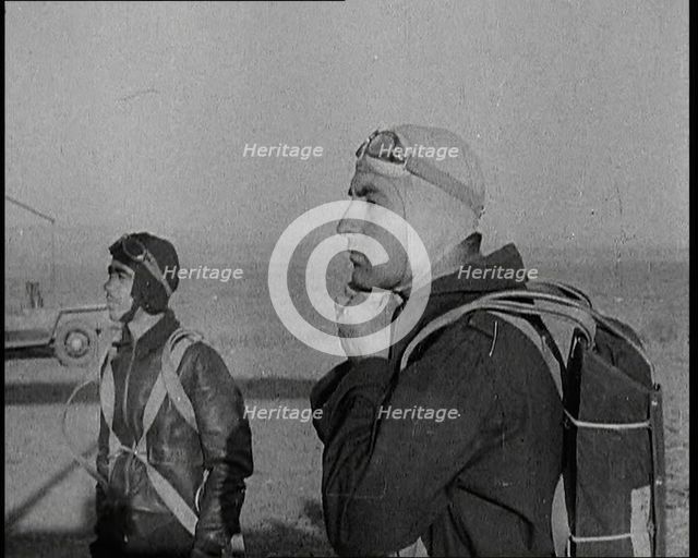 Pilot and Rear Gunner of Biplane Readying Themselves To Board Their Plane With One Adjusting...,1937 Creator: British Pathe Ltd.