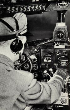 Pilot in the cockpit of a Douglas DC-3 aeroplane, 1940
