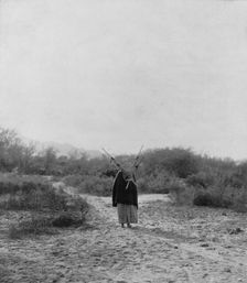 Pima woman, with burden basket on back, walking away from camera, Pima, Arizona, c1907. Creator: Edward Sheriff Curtis