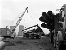 Pipe wrapping to prevent corrosion on steel pipes, Old Denaby, South Yorkshire, 1961. Creator: Michael Walters