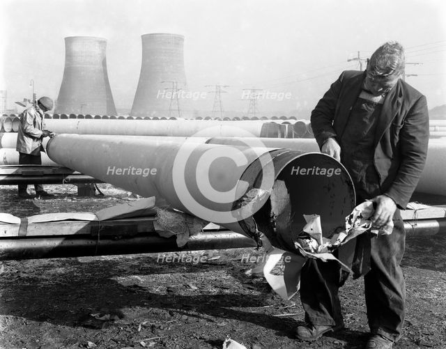 Pipe wrapping to prevent corrosion on steel pipes, Old Denaby, South Yorkshire, 1961. Artist: Michael Walters