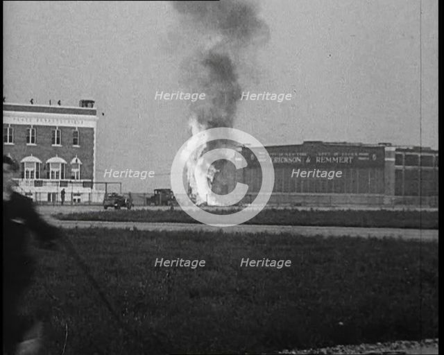 Plume of Flame Emitting from the ‘Bellanca’ Crash as People Attend to Wreckage, 1933. Creator: British Pathe Ltd.