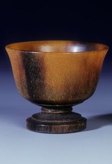 Plain circular rhino horn cup with turned stepped foot and stem, Qing dynasty, China, 18th century