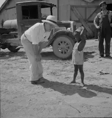Plantation owner with one of the Negro plantation children, Aldridge Plantation, Mississippi, 1937. Creator: Dorothea Lange