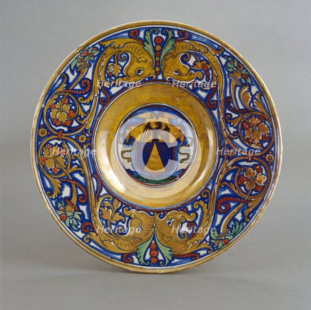 Plate with border of foliate scrollwork with dolphin heads and cornucopias; in the center..., 1524. Creator: Giorgio Andreoli workshop.