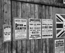 Playbills on a hoarding, London, World War I, 1914. Artist: Adolph Augustus Boucher