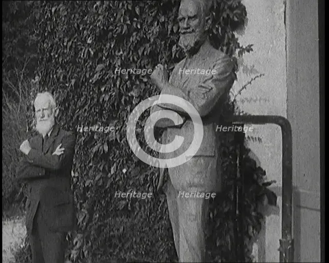 Playwright George Bernard Shaw Standing Next To a Statue of Himself, 1920s. Creator: British Pathe Ltd.