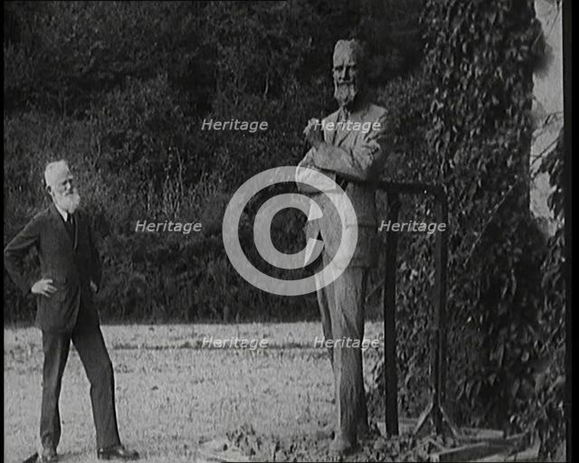 Playwright George Bernard Shaw Standing Next To a Statue of Himself, 1920s. Creator: British Pathe Ltd.