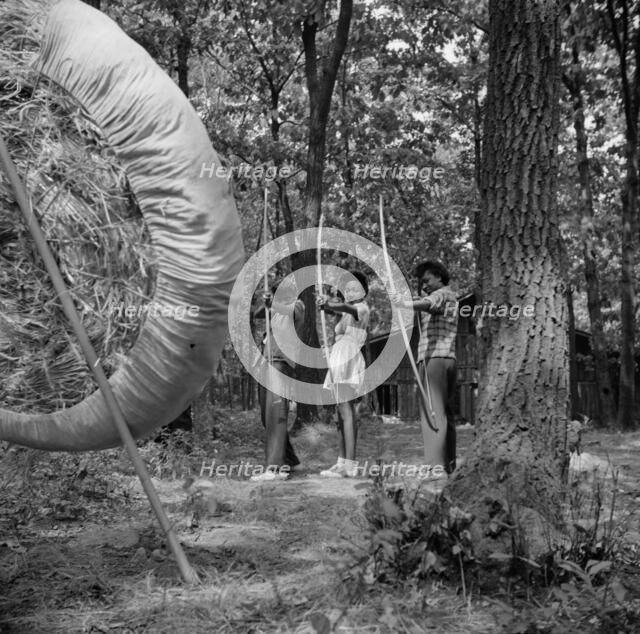 Practicing on the archery range at Camp Fern Rock, Bear Mountain, New York, 1943 Creator: Gordon Parks.