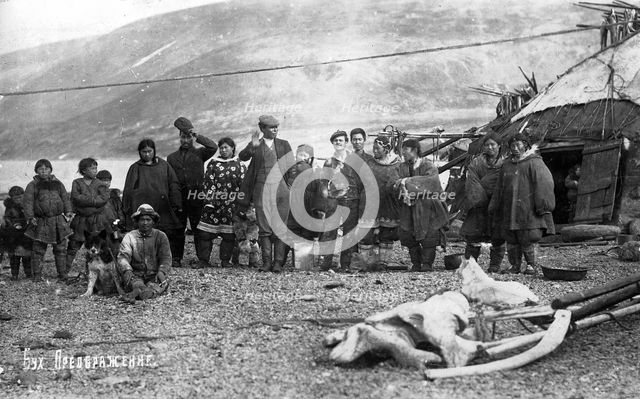 Preobrazhenie Bay: Chukchi in front of their home, in national traditional fur clothing..., 1910-29. Creator: Ivan Emelianovich Larin.