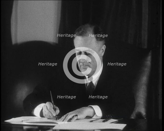 President Franklin D Roosevelt Signing Papers Behind a Desk, 1930s. Creator: British Pathe Ltd.