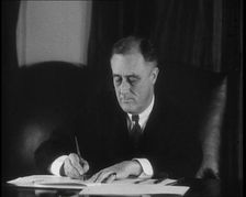 President Franklin D Roosevelt Signing Papers Behind a Desk, 1930s. Creator: British Pathe Ltd