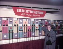 Press Button Listening HMV, Oxford Street, London, 1953. Creator: Arthur Charles Kirby Ware