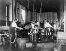 Pressmen at work in printing shop, Hampton Institute, Hampton, Virginia, 1899 or1900. Creator: Frances Benjamin Johnston