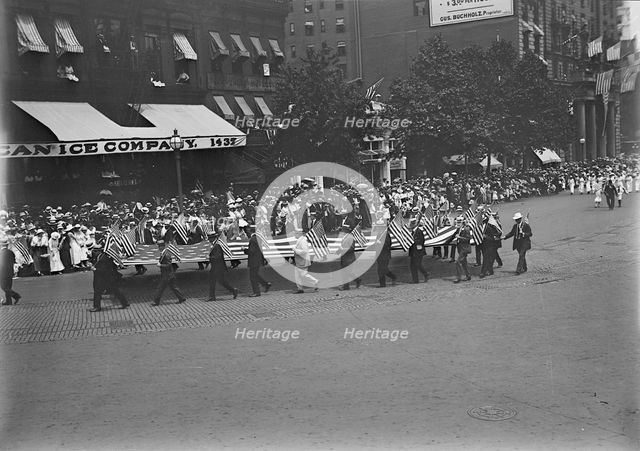 Preparedness Parade - Men Carrying Huge Flag, 1916. Creator: Harris & Ewing.