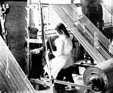 Preparing for the weaving: drawing-in, 1909. Creator: Unknown