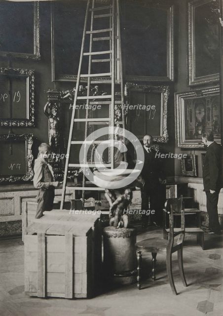 Preparing paintings for evacuation from one of the Italian halls at the Hermitage, 1917.