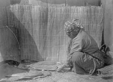 Preparing salmon-Wishram, c1910. Creator: Edward Sheriff Curtis