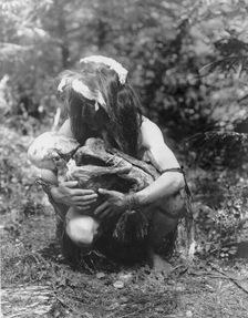 Preparing to eat the mummy, c1911. Creator: Edward Sheriff Curtis