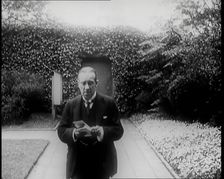 Prime Minister of Britain, Stanley Baldwin, Walking in the Gardens at Chequers Whilst Reading, 1926. Creator: British Pathe Ltd