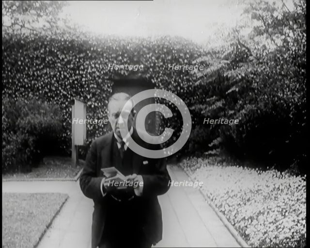 Prime Minister of Britain, Stanley Baldwin, Walking in the Gardens at Chequers Whilst Reading, 1926. Creator: British Pathe Ltd.