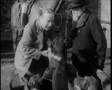 Prime Minister Stanley Baldwin Petting Dogs. Beside Him a Male Civilian Stands Next to a Horse, 1924 Creator: British Pathe Ltd