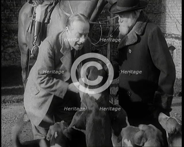 Prime Minister Stanley Baldwin Petting Dogs. Beside Him a Male Civilian Stands Next to a Horse, 1924 Creator: British Pathe Ltd.