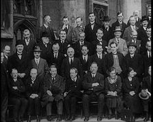 Prime Minister Ramsay MacDonald Sitting on a Chair Smoking Whilst Surrounded by Members of..., 1924. Creator: British Pathe Ltd
