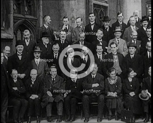 Prime Minister Ramsay MacDonald Sitting on a Chair Smoking Whilst Surrounded by Members of..., 1924. Creator: British Pathe Ltd.