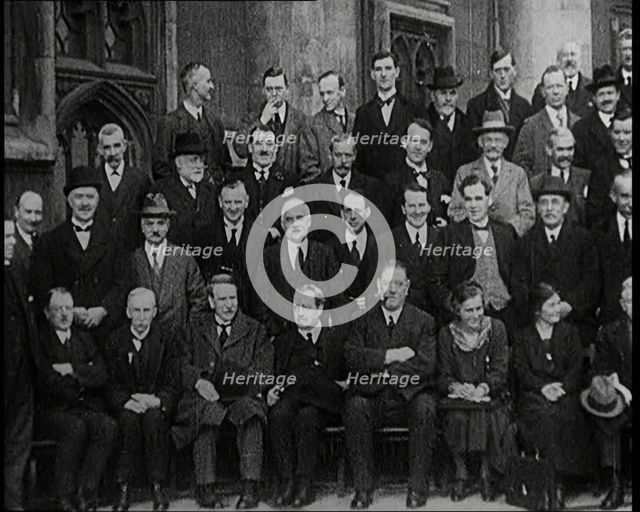 Prime Minister Ramsay MacDonald Sitting on a Chair Smoking Whilst Surrounded by Members of..., 1924. Creator: British Pathe Ltd.