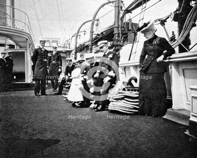 Prince Olav (1903-1991), the future King Olav V of Norway, conversing with naval officers, 1908.Artist: Queen Alexandra
