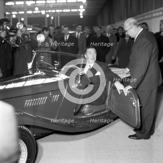 Prince Bertil tests a convertible at the car showroom in Stockholm, Sweden, 1954. 
 Creator: Unknown.