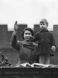 Princess Elizabeth and a two year old Prince Charles wave from Buckingham Palace, 1950. Creator: Unknown