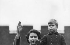 Princess Elizabeth and a two year old Prince Charles wave from Buckingham Palace, 1950.   Creator: Unknown.