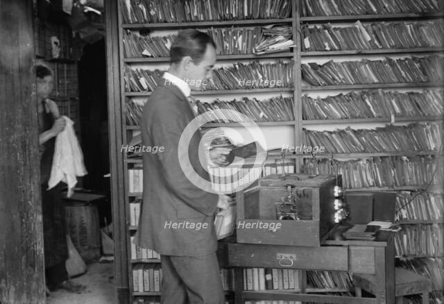 Printing the Bain News Service photos using a Bain-McDonald auto printer, between c1910 and c1915. Creator: Bain News Service.