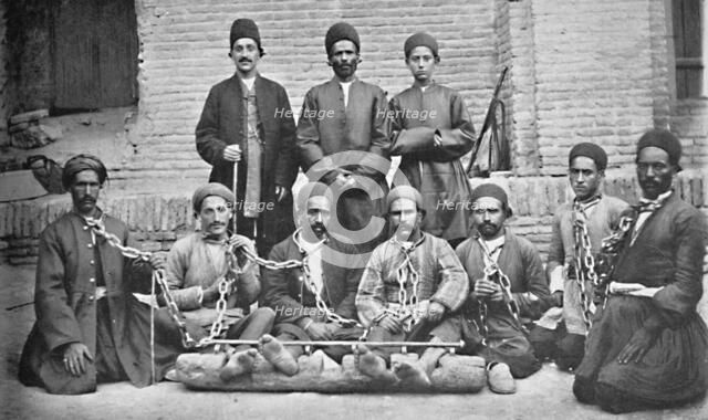 Prisoners and gaolers in a prison yard, Nahavand, Persia, 1902. Artist: Unknown.