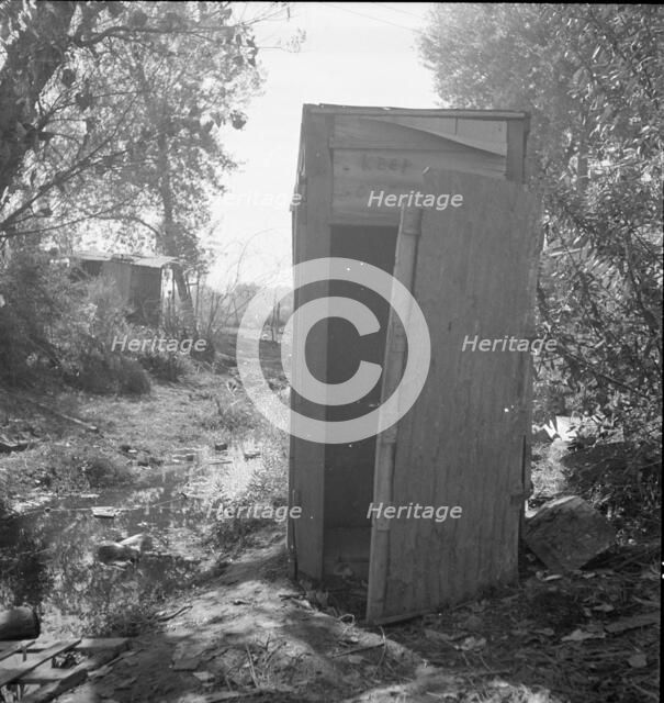 Privy in cotton camp for migratory workers, California, 1936. Creator: Dorothea Lange.